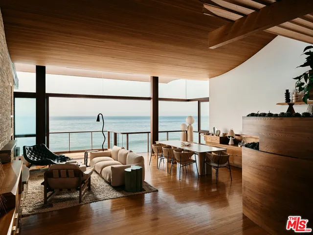 a living room with furniture and a floor to ceiling window