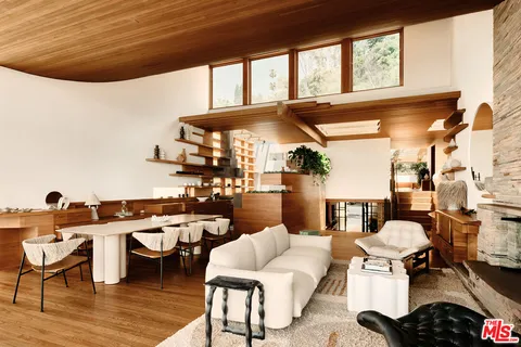 a view of a patio with a dining table and chairs with wooden floor
