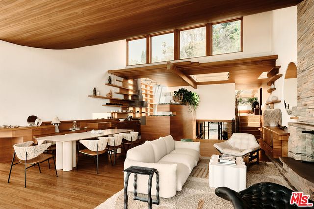 a view of a patio with a dining table and chairs with wooden floor