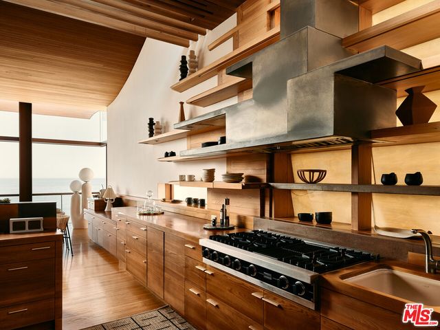 a kitchen with stove and cabinets