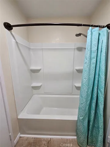 a bathroom with a shower and a tub
