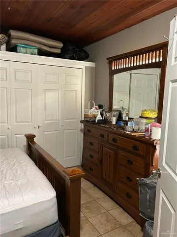 a room with a bed and a mirror