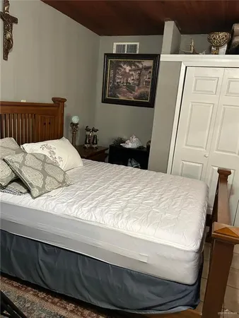 a bed sitting in a bedroom and dresser