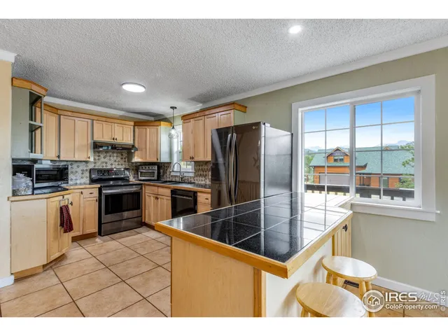 a kitchen with stainless steel appliances refrigerator stove microwave and cabinets