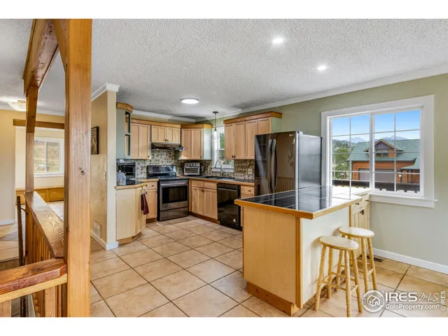 a kitchen with stainless steel appliances a microwave a refrigerator and cabinets