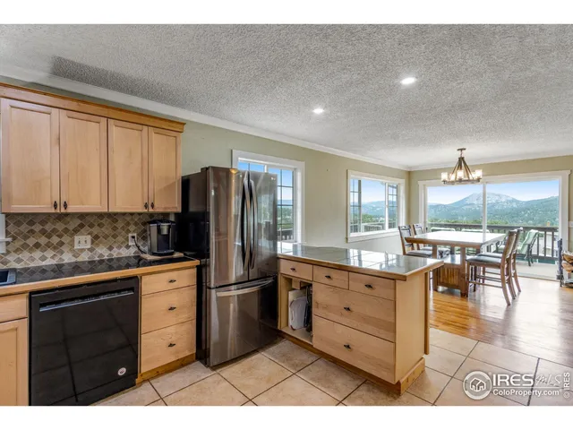 a open kitchen with stainless steel appliances kitchen island granite countertop a sink and cabinets