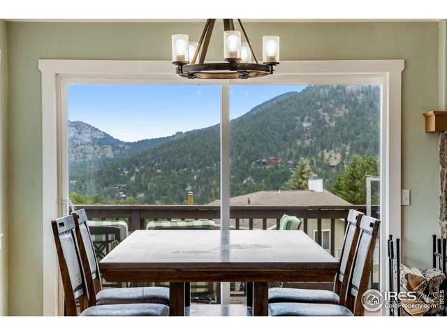 a dining room with furniture a chandelier and wooden floor
