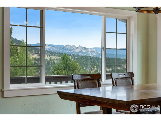a living room with furniture a table and kitchen view