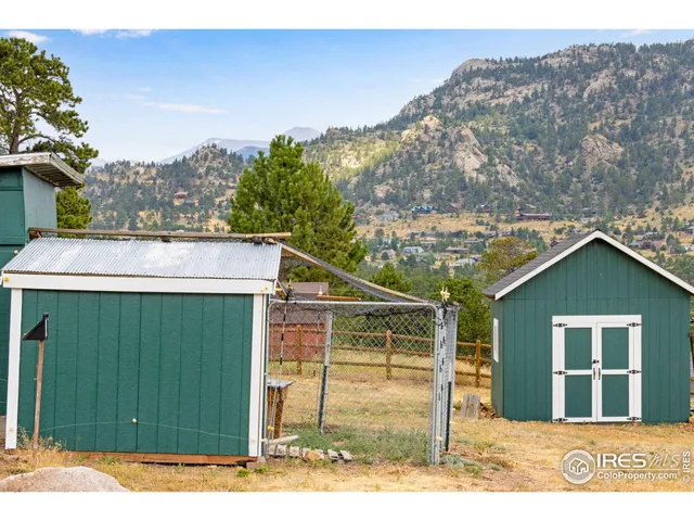 a view of a wooden house with a yard