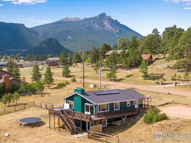 a aerial view of a house with a yard swimming pool and mountain view