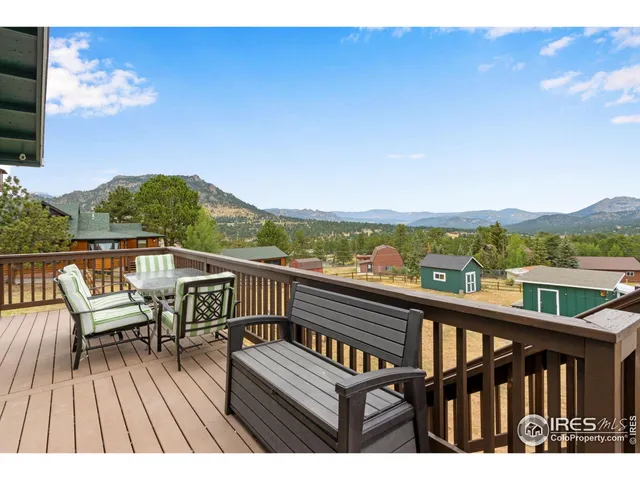 a view of a balcony with wooden floor and city view
