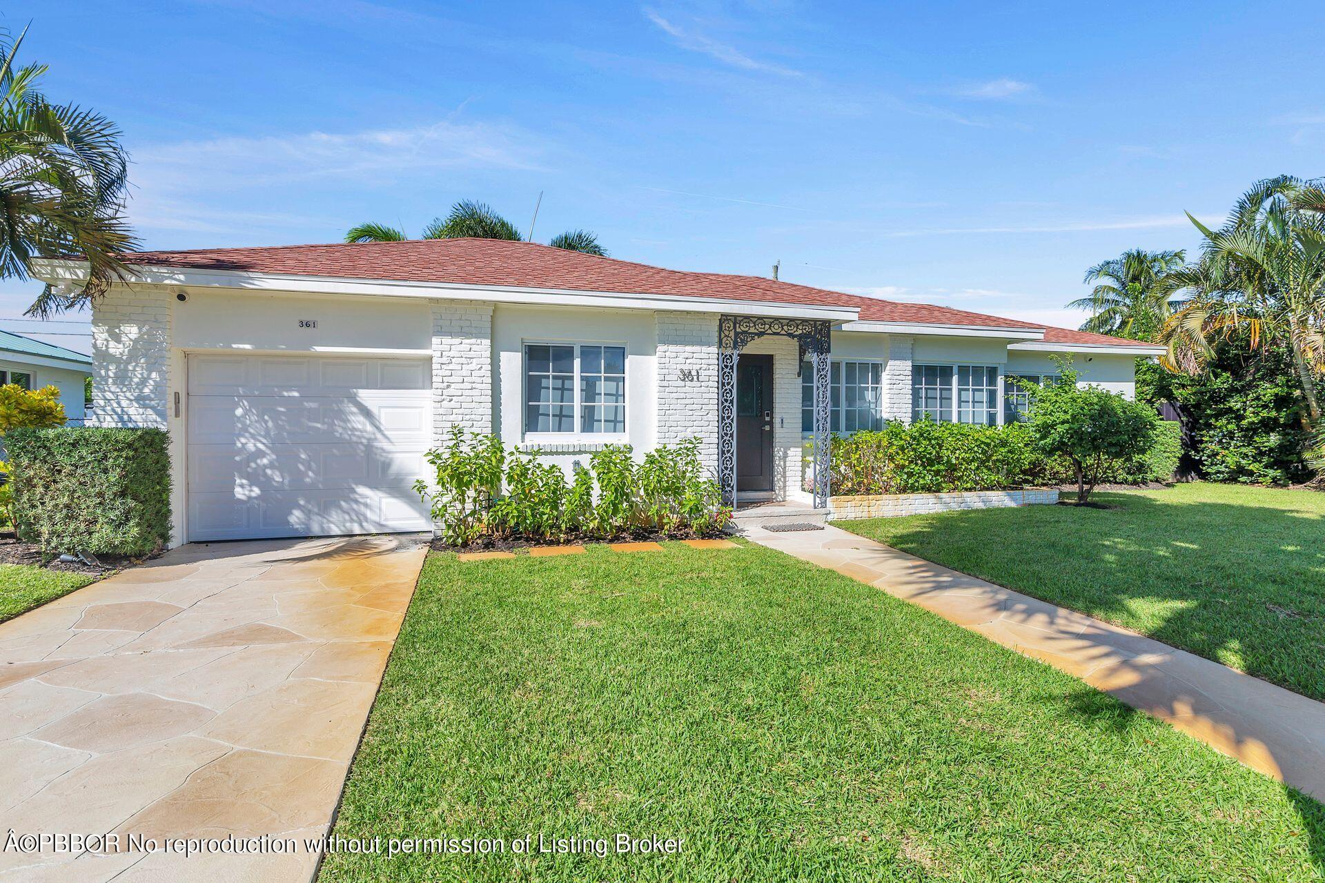 361 Franklin Road West Palm Beach, FL 33405 - Photo 28 of 32 a front view of a house with a yard and potted plants