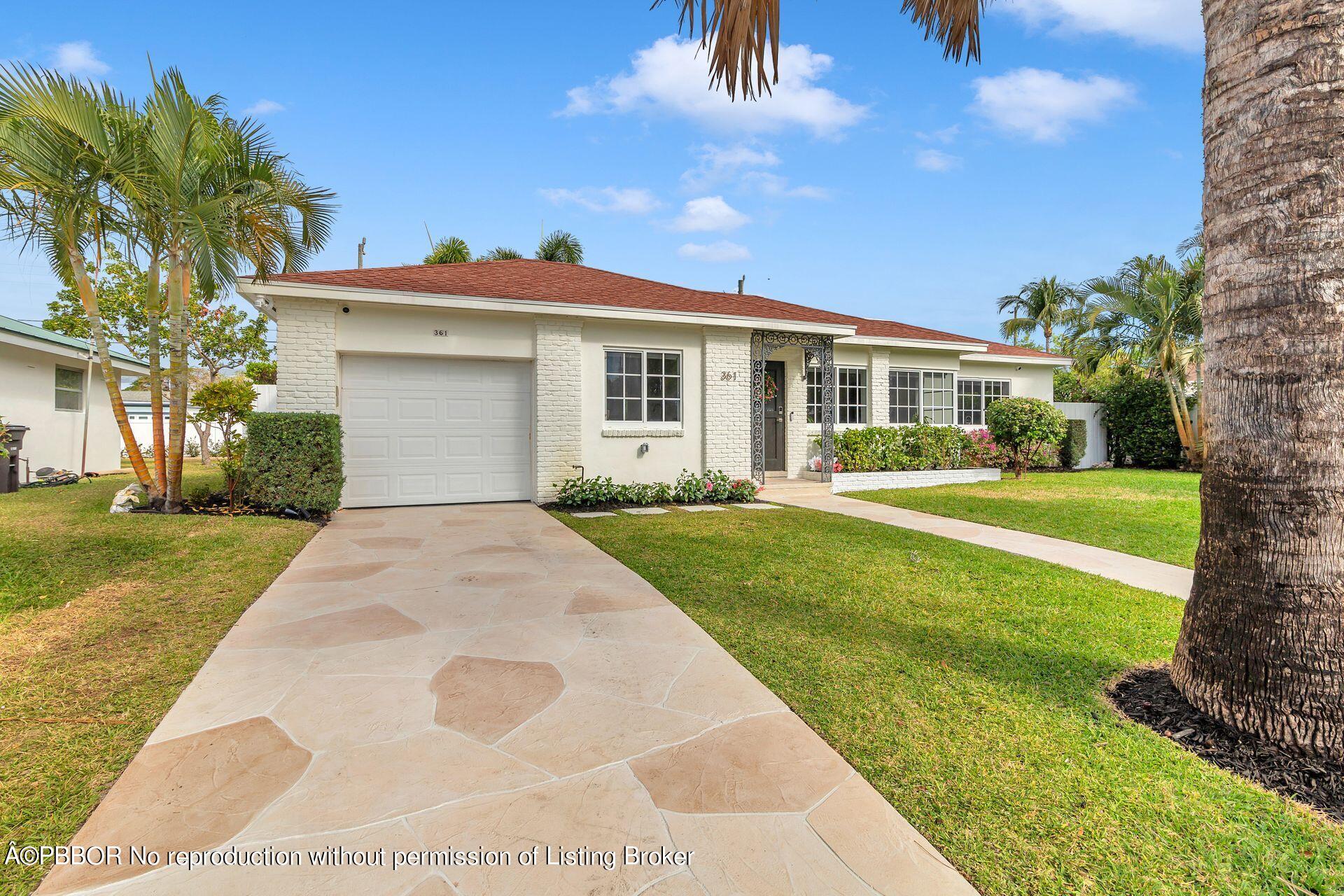 361 Franklin Road West Palm Beach, FL 33405 - Photo 3 of 32 a front view of a house with a yard and potted plants