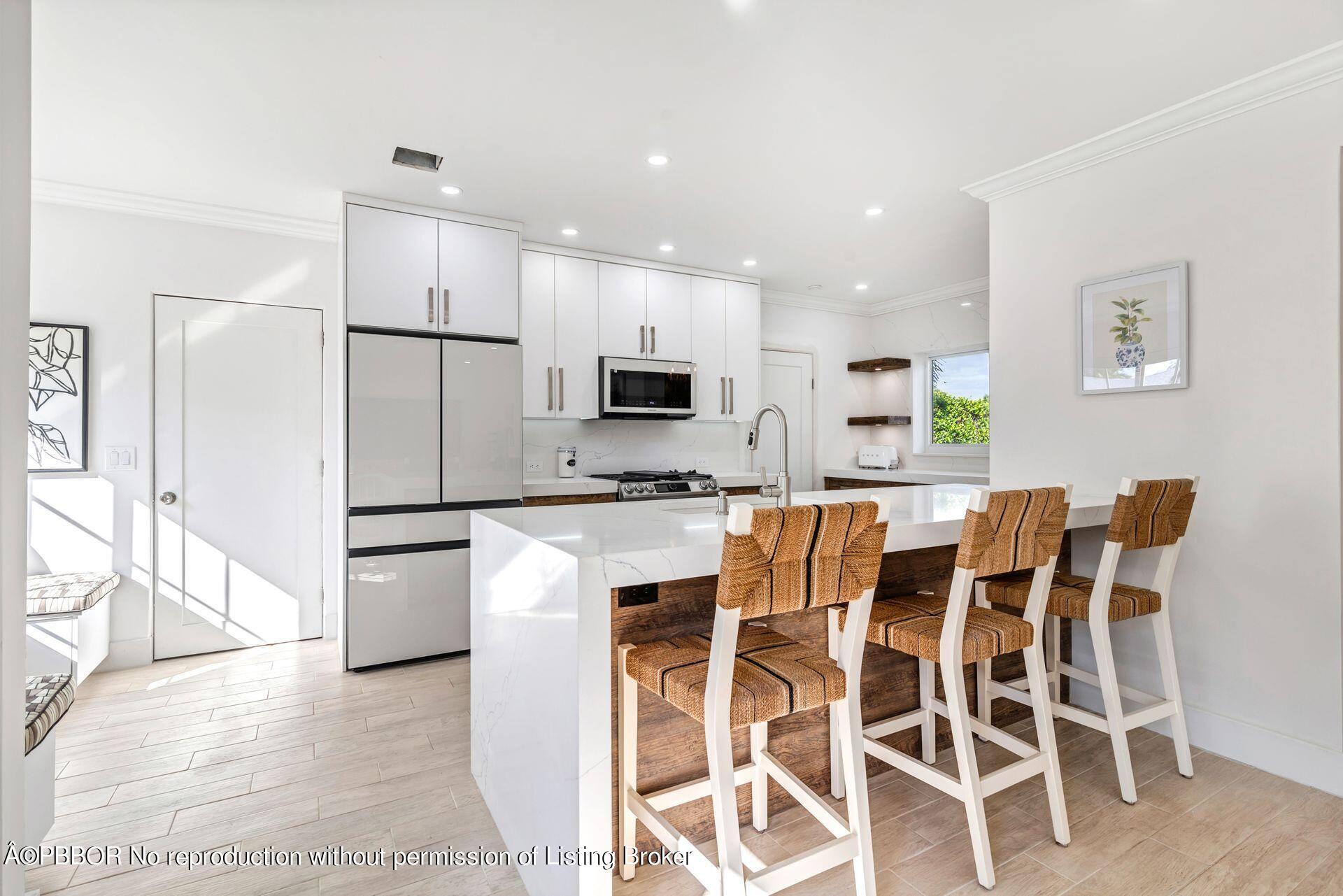 361 Franklin Road West Palm Beach, FL 33405 - Photo 8 of 32 a kitchen with stainless steel appliances kitchen island granite countertop a refrigerator and a stove top oven