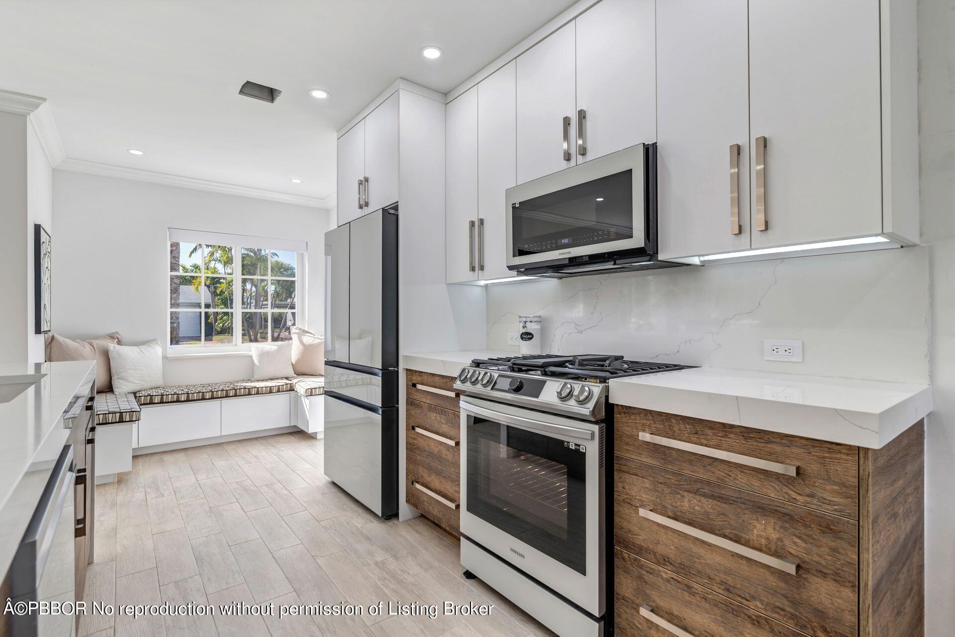 361 Franklin Road West Palm Beach, FL 33405 - Photo 9 of 32 a kitchen with stainless steel appliances a stove microwave and refrigerator