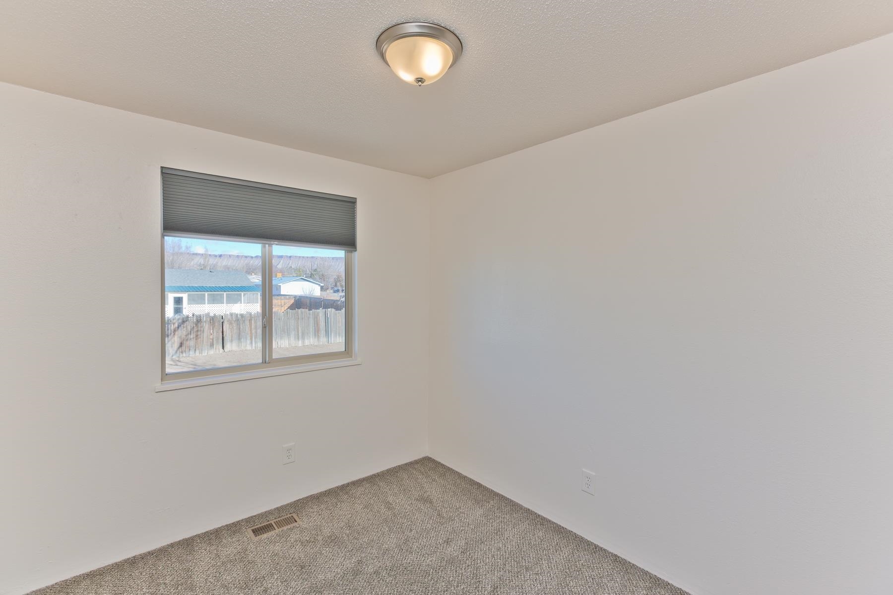 3212 D D 1/4 Road Clifton, CO 81520 - Photo 9 of 25 an empty room with windows