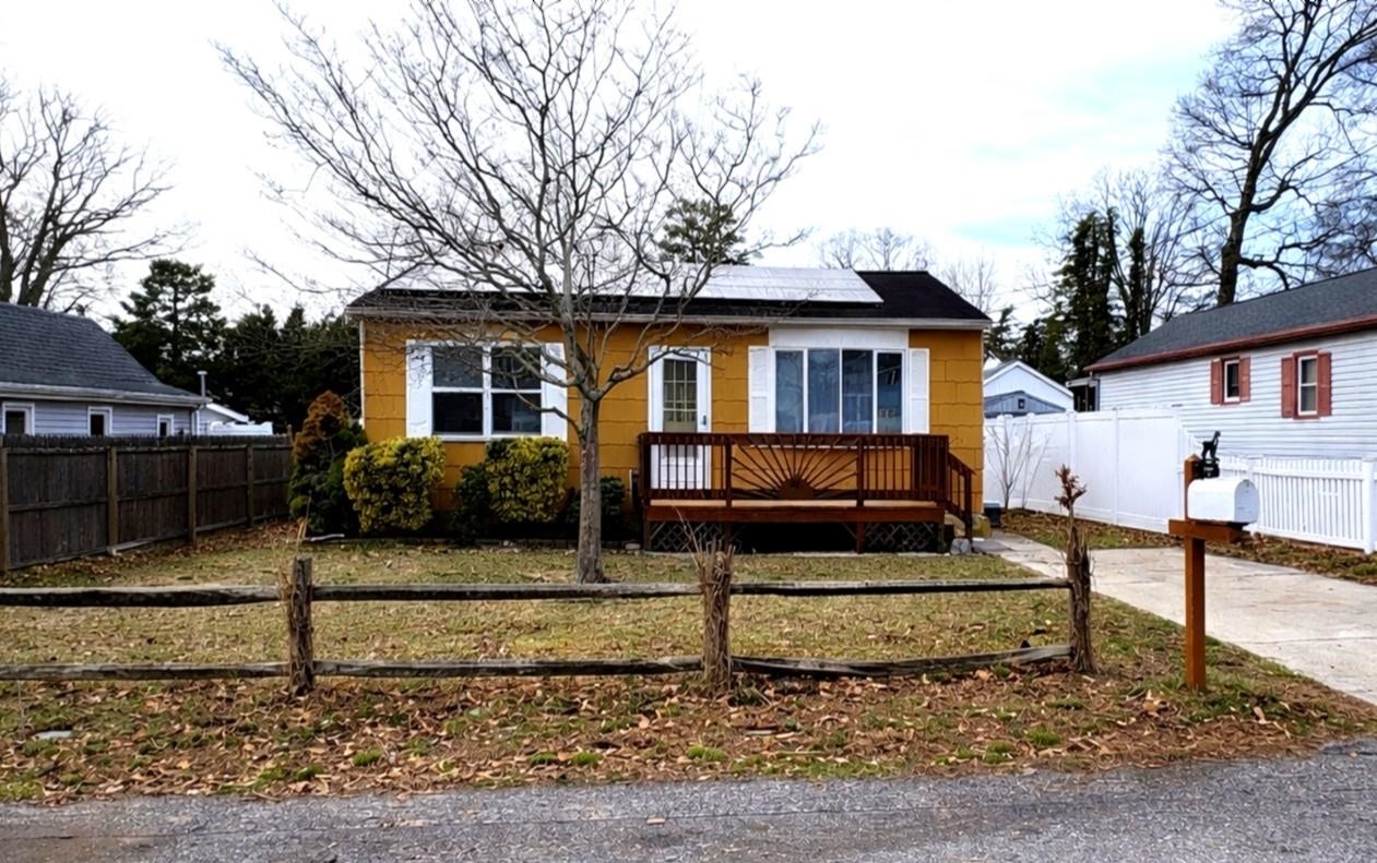 a front view of a house with garage next to a road