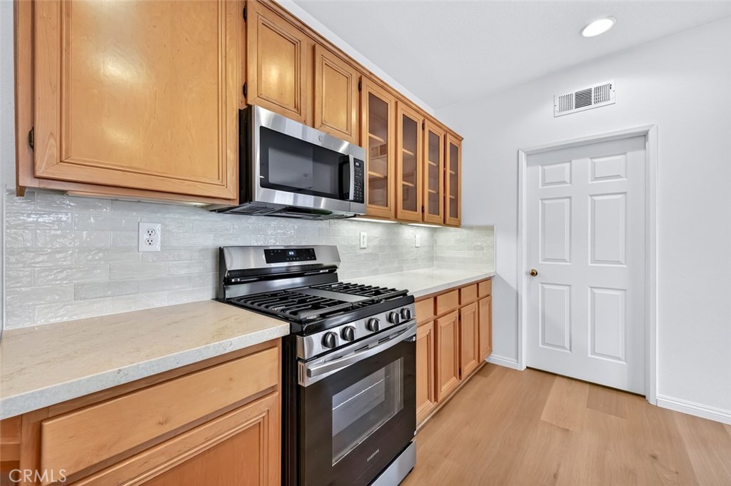 447 Ridgeway Irvine, CA 92620 - Photo 75 of 88 a kitchen with stainless steel appliances granite countertop a stove microwave and cabinets