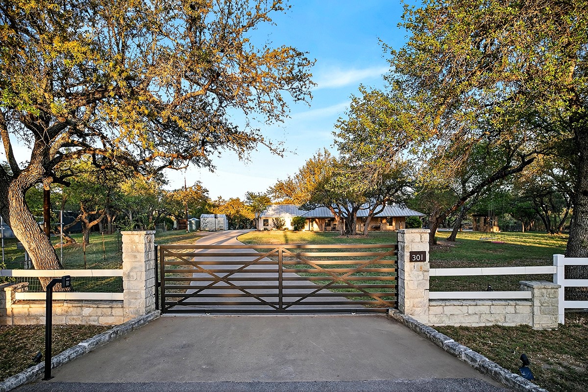 301 Medlin Creek Loop Dripping Springs, TX 78620 - Photo 37 of 40 Gate featuring a fenced front yard