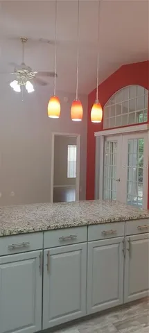 a bathroom with a granite countertop sink a large mirror and vanity