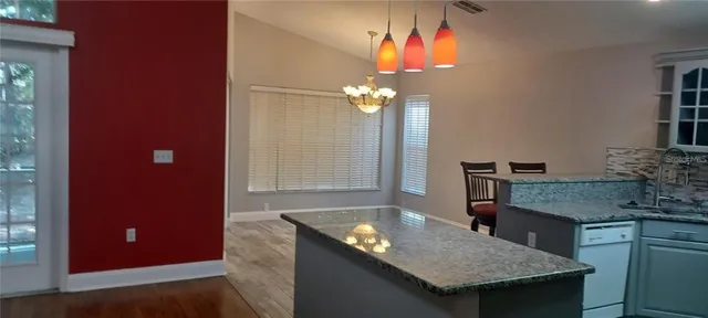 a dining room with a table and chairs