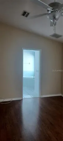 an empty room with wooden floor and closet