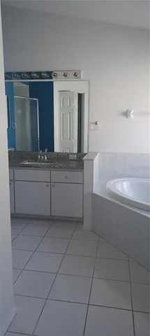 a bathroom with a bathtub and a sink
