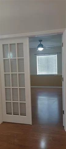 a view of a room with wooden floor and windows