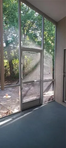 a view of a glass door and a yard from a window