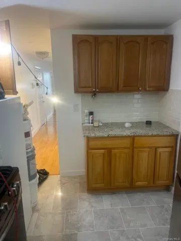 a view of kitchen with stainless steel appliances granite countertop a sink and a cabinets
