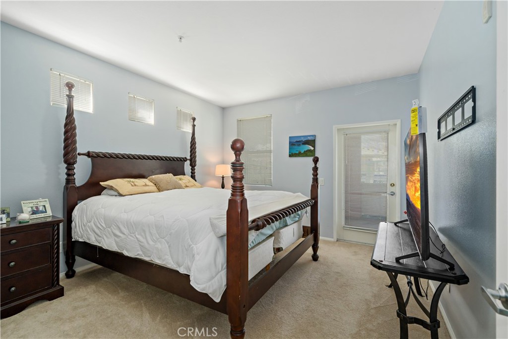 31214 Taylor Lane Temecula, CA 92592 - Photo 11 of 24 a bedroom with a bed and a flat tv screen on wall