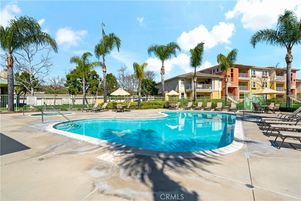 31214 Taylor Lane Temecula, CA 92592 - Photo 17 of 24 a view of a swimming pool with a lawn chairs and palm trees