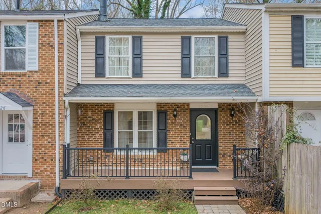 front view of a brick house with large windows