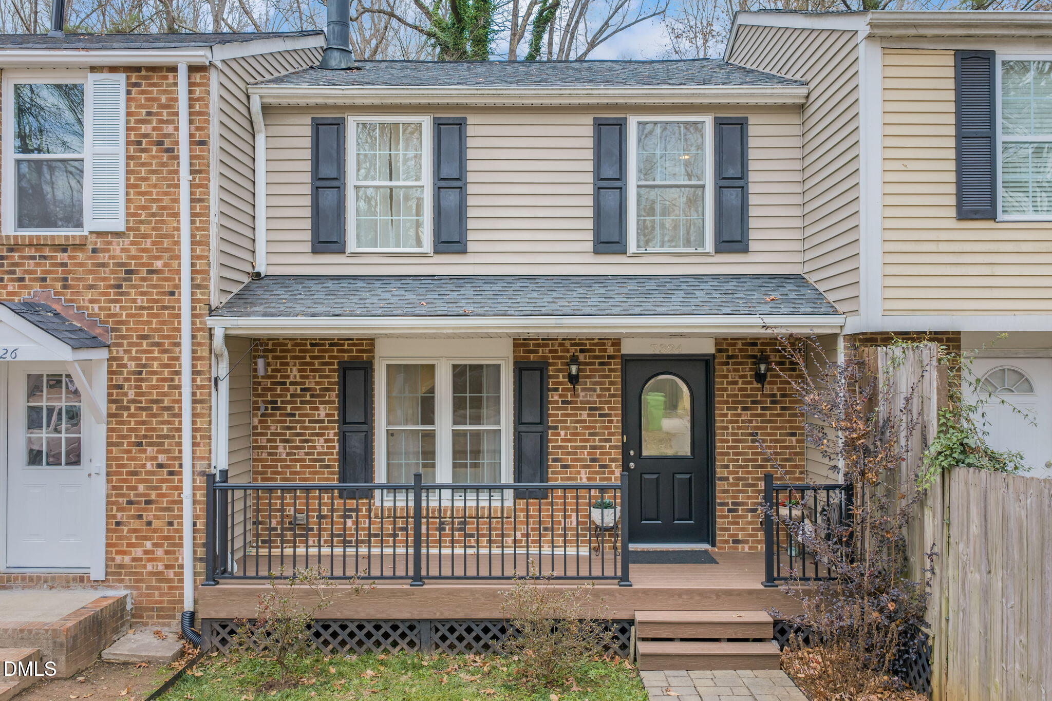 front view of a brick house with large windows