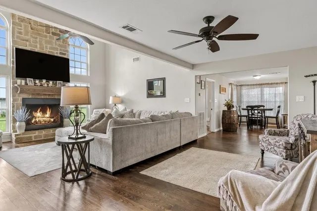 a living room with furniture a flat screen tv and a fireplace