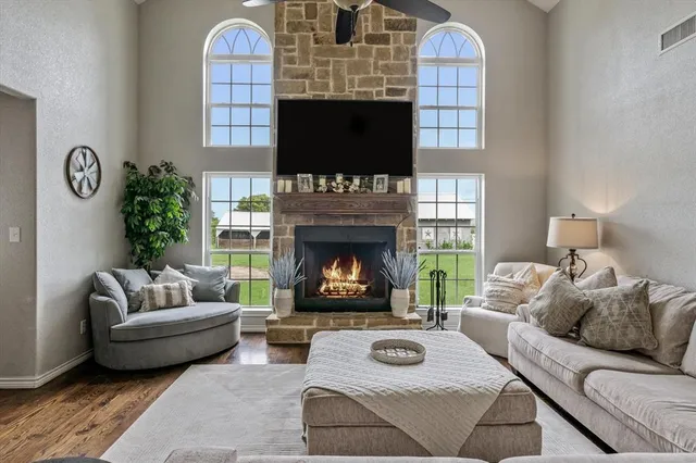 a living room with furniture a fireplace and a flat screen tv