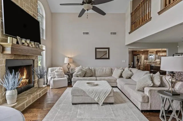 a living room with furniture a flat screen tv and a fireplace