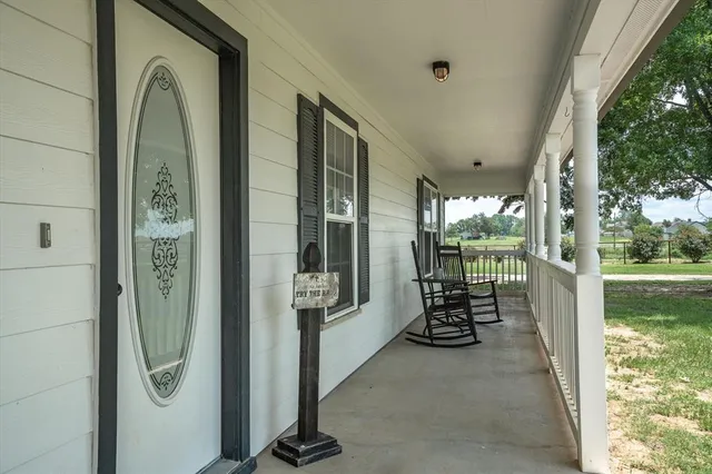 a couple of chairs in a balcony with outdoor view