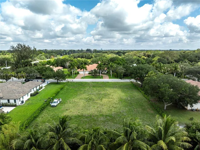 an aerial view of residential houses with outdoor space and swimming pool