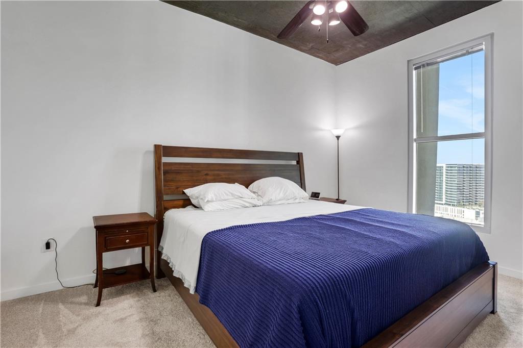 250 Pharr Road Northeast, Unit 2005 Atlanta, GA 30305 - Photo 13 of 49 a bedroom with a bed and a chandelier