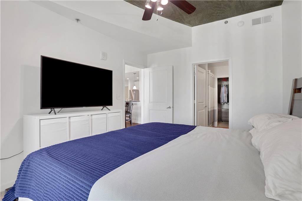 250 Pharr Road Northeast, Unit 2005 Atlanta, GA 30305 - Photo 15 of 49 a bedroom with a bed and a flat screen tv