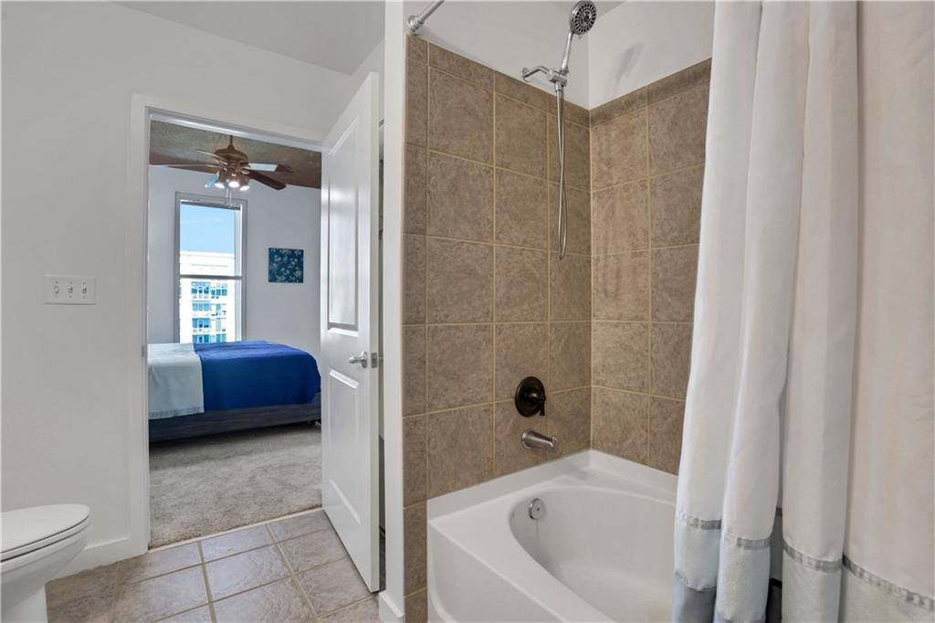 250 Pharr Road Northeast, Unit 2005 Atlanta, GA 30305 - Photo 18 of 49 a bathroom with a tub a toilet and a shower