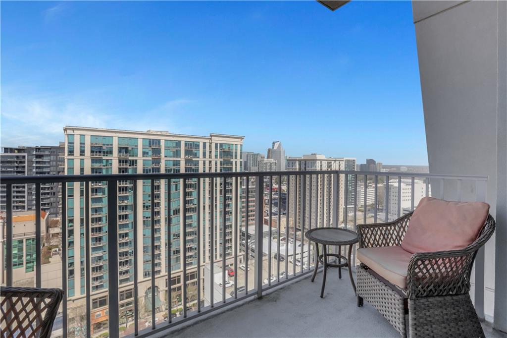 250 Pharr Road Northeast, Unit 2005 Atlanta, GA 30305 - Photo 23 of 49 a view of a balcony with chair and wooden floor