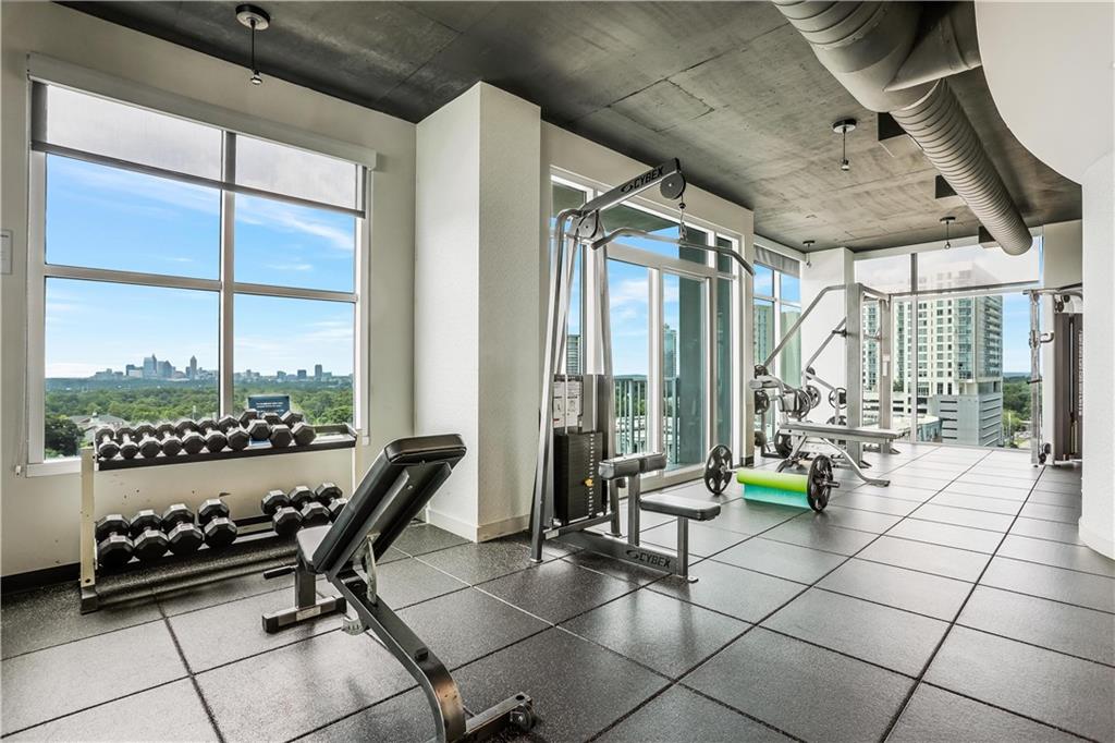 250 Pharr Road Northeast, Unit 2005 Atlanta, GA 30305 - Photo 30 of 49 a room with gym equipment and a large window