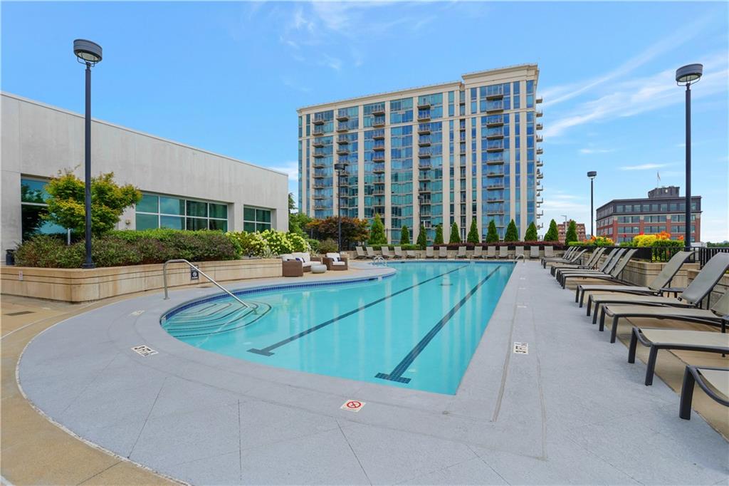 250 Pharr Road Northeast, Unit 2005 Atlanta, GA 30305 - Photo 33 of 49 a swimming pool with outdoor seating and plants