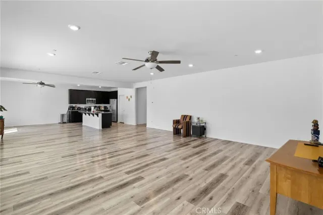 a view of a kitchen with furniture and wooden floor