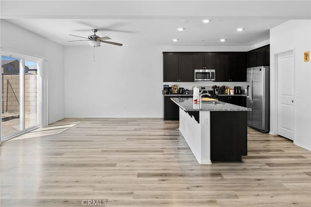12487 Sunset Road Victorville, CA 92392 - Photo 14 of 44 a kitchen with stainless steel appliances granite countertop a stove top oven and cabinets
