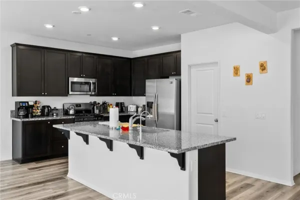 a kitchen with a stove sink and microwave