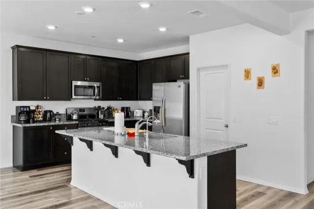 a kitchen with a stove sink and microwave