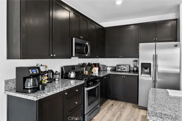 a living room with furniture and kitchen view